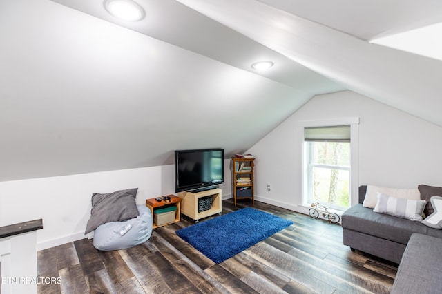 living area featuring dark wood-type flooring, lofted ceiling, and baseboards