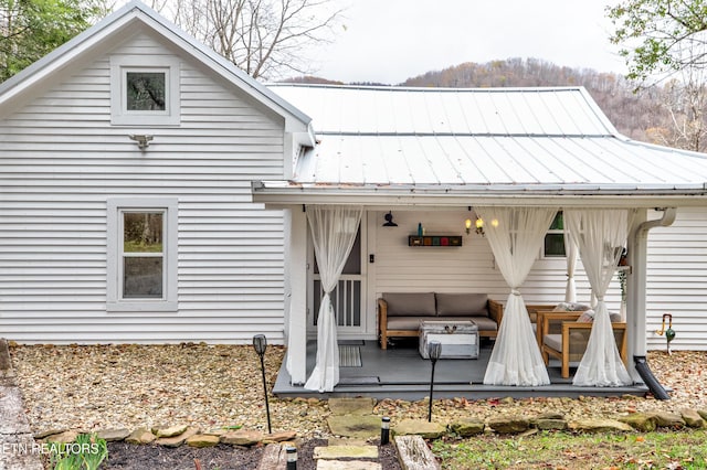 rear view of house featuring a standing seam roof and metal roof