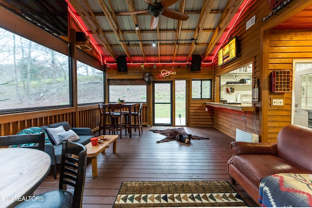 sunroom / solarium with ceiling fan and visible vents