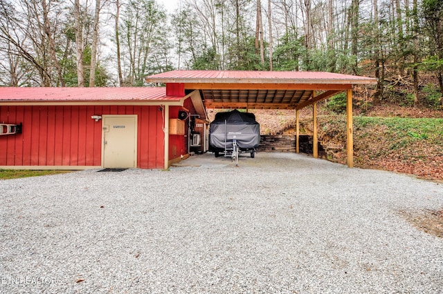 view of outbuilding with a carport and driveway