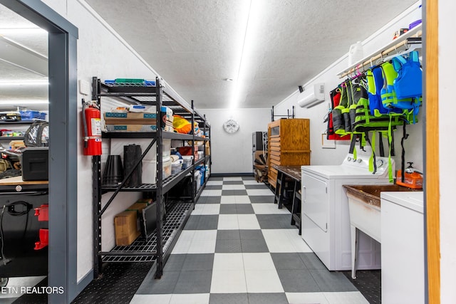 laundry area with dark floors, washing machine and dryer, a textured ceiling, and laundry area