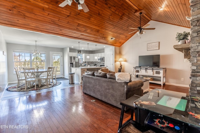 living area with baseboards, dark wood finished floors, wood ceiling, high vaulted ceiling, and ceiling fan with notable chandelier