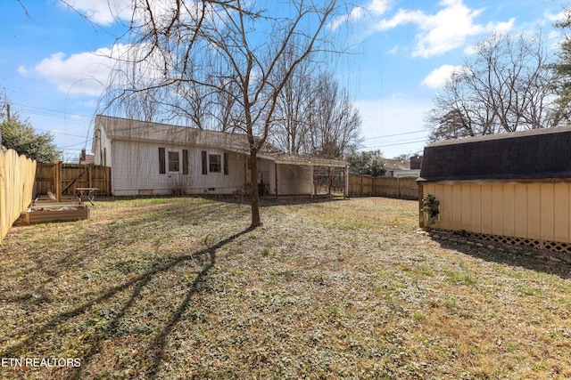 exterior space featuring crawl space, a fenced backyard, a lawn, and an outdoor structure