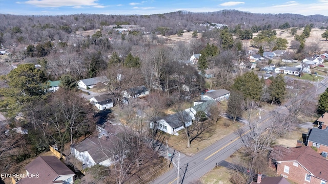 aerial view featuring a wooded view and a residential view