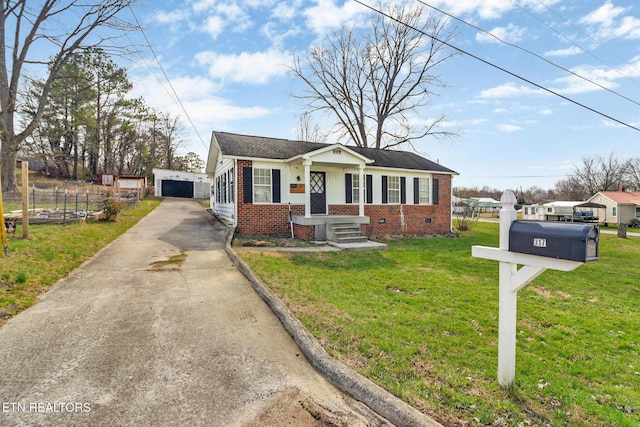 bungalow featuring crawl space, a front lawn, an outdoor structure, and brick siding