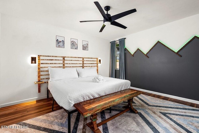 bedroom with ceiling fan and dark wood-type flooring