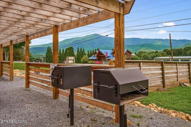 exterior space featuring a mountain view and a pergola