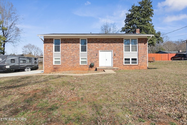 raised ranch with a front lawn