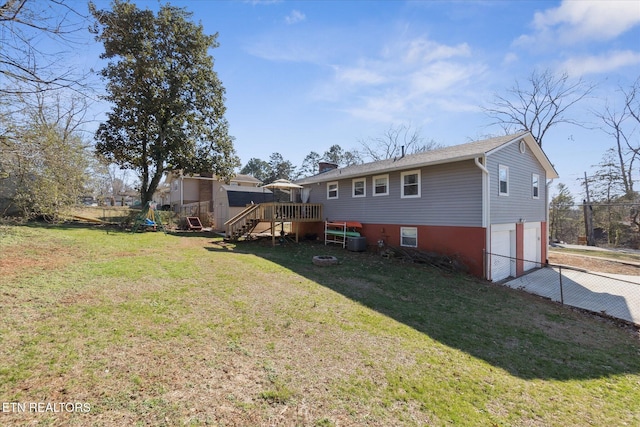 rear view of property with a deck and a lawn