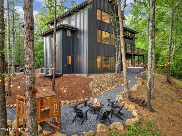 back of house featuring an outdoor fire pit