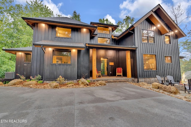 view of front facade featuring a shingled roof and board and batten siding