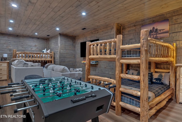 recreation room featuring wooden walls, wooden ceiling, wood finished floors, and recessed lighting