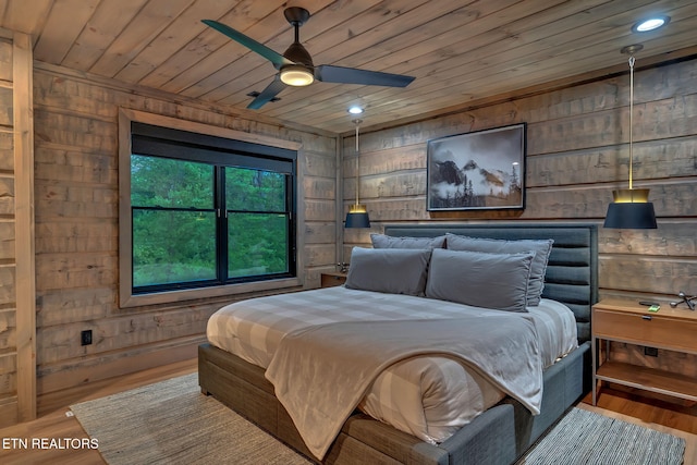 bedroom featuring wood ceiling, wooden walls, and wood finished floors