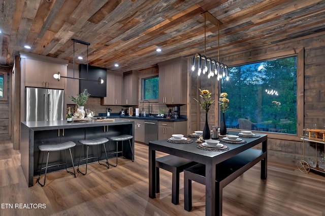 dining space featuring recessed lighting, wooden ceiling, and wood finished floors