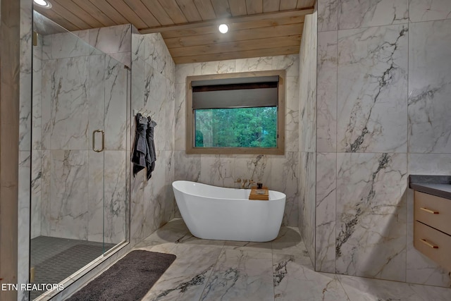 bathroom featuring marble finish floor, a marble finish shower, a freestanding bath, wood ceiling, and vanity