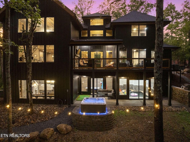 back of house with a patio area and an outdoor hangout area