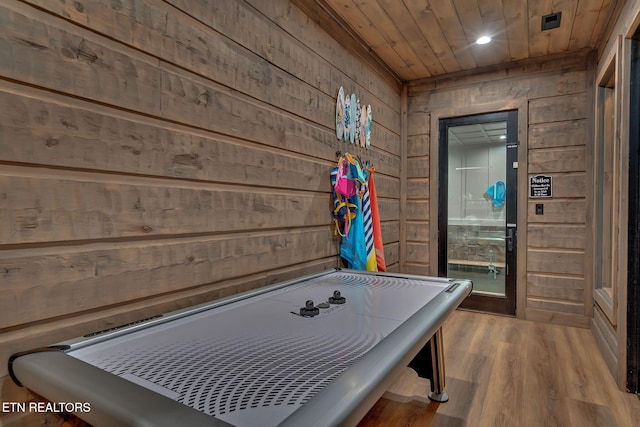 playroom featuring wood ceiling, wooden walls, and wood finished floors