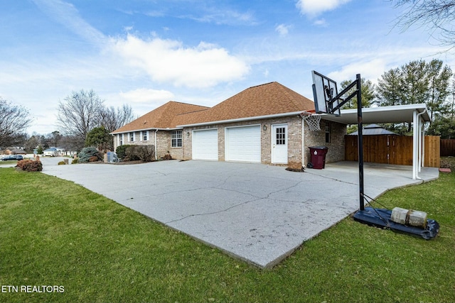 view of home's exterior featuring a lawn, aphalt driveway, an attached garage, fence, and brick siding