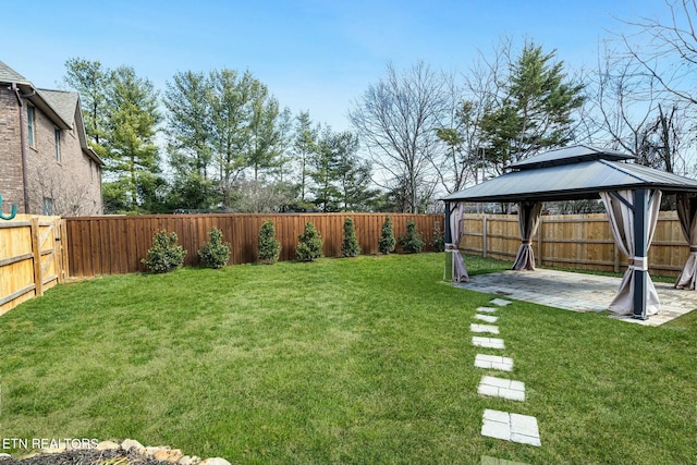 view of yard with a patio area, a fenced backyard, and a gazebo