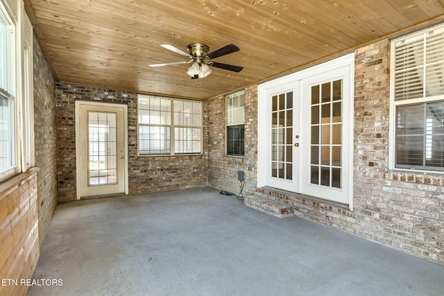 spare room featuring wood ceiling and brick wall