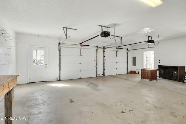 garage featuring electric panel and a garage door opener