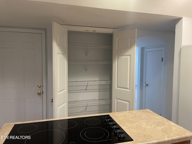 kitchen with light countertops and black electric stovetop