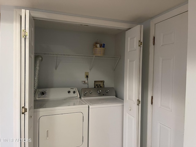 clothes washing area featuring laundry area and washing machine and clothes dryer