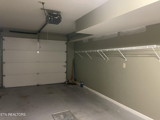 garage featuring baseboards and a garage door opener