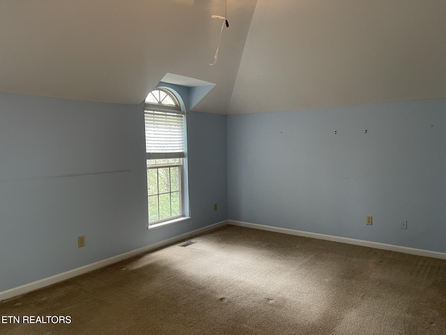 bonus room with lofted ceiling, carpet flooring, baseboards, and a wealth of natural light