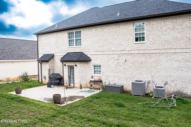 12309 Cotton Blossom Ln, Knoxville, TN 37934 - rear view of house featuring central AC, a yard, a patio, and brick siding