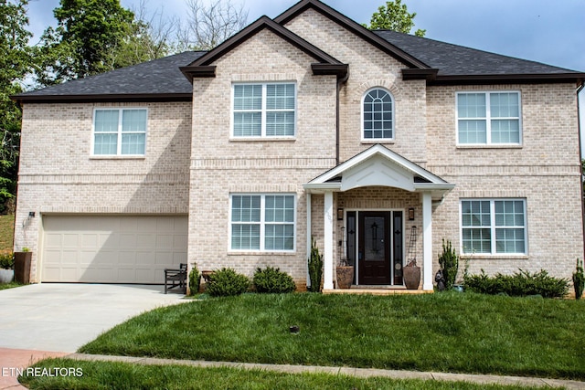 12309 Cotton Blossom Ln, Knoxville, TN 37934 - view of front of property with a garage, a front lawn, concrete driveway, brick siding, and a shingled roof