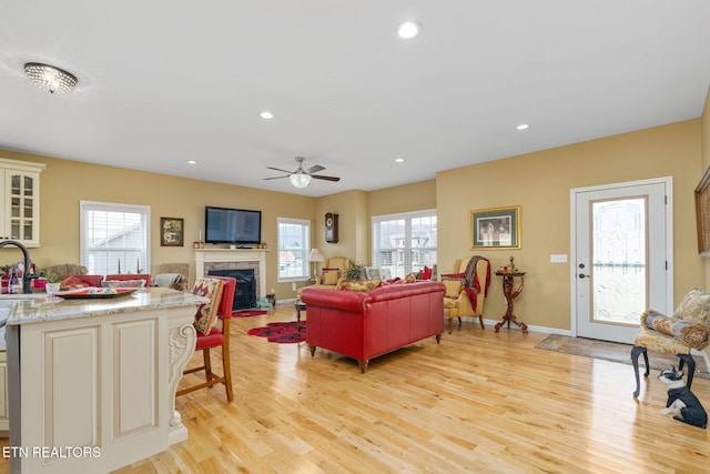 living room featuring ceiling fan and light hardwood / wood-style flooring