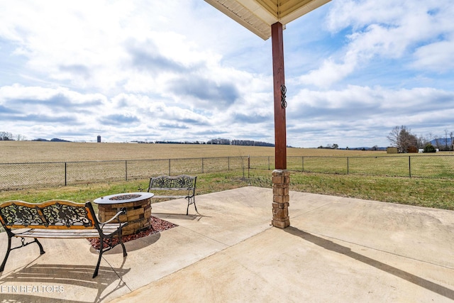 view of patio / terrace featuring a rural view and a fire pit