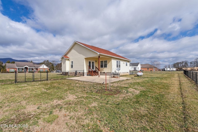 back of house featuring a yard and a patio area