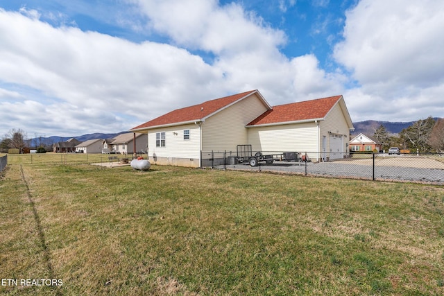 view of side of property featuring a yard and a mountain view