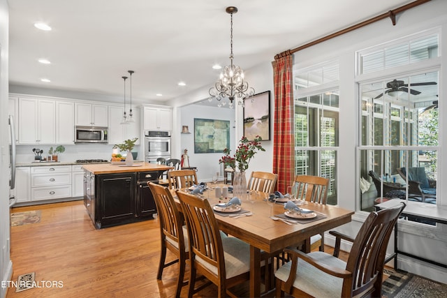 dining room with light wood-type flooring, plenty of natural light, recessed lighting, and ceiling fan with notable chandelier