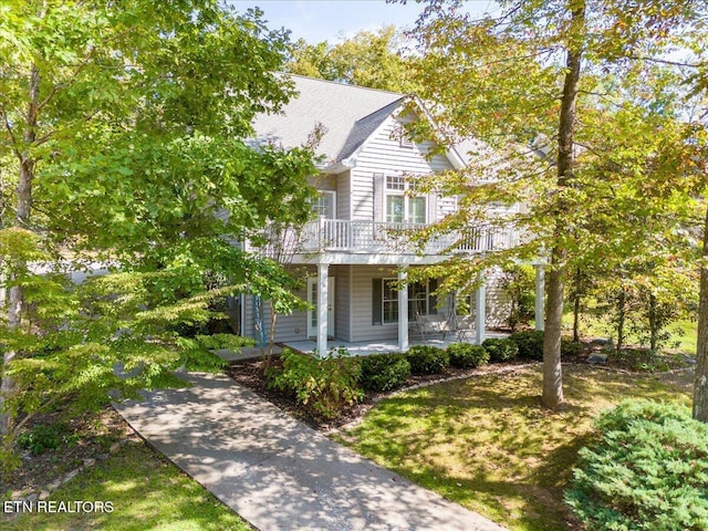 view of front of property with a porch and a balcony