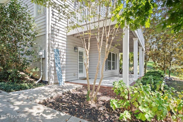 view of side of property featuring covered porch