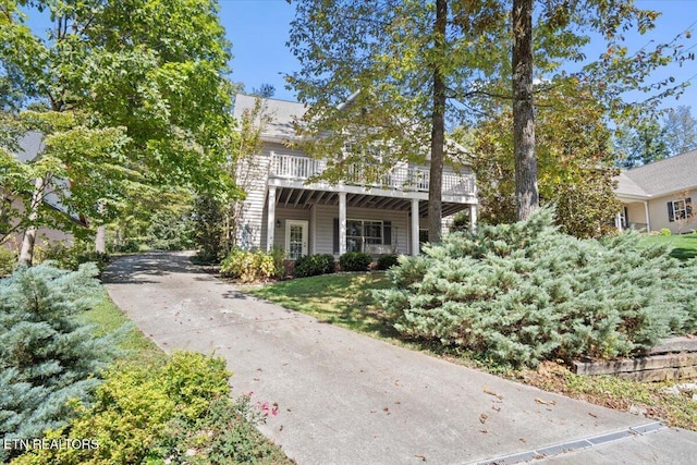 view of front of house with a deck and driveway