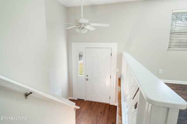 foyer with dark hardwood / wood-style flooring and ceiling fan