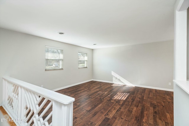 empty room featuring dark wood-type flooring