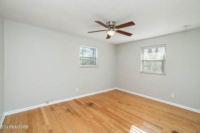 empty room with hardwood / wood-style floors and ceiling fan