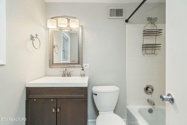 full bathroom with tiled shower / bath combo, toilet, and vanity