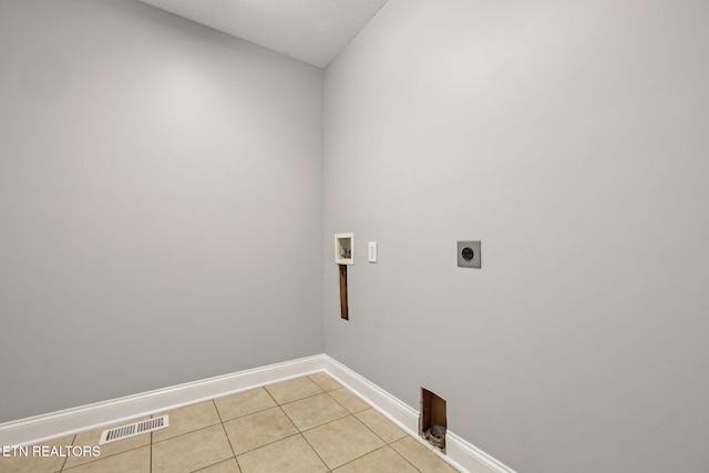 clothes washing area featuring light tile patterned floors, laundry area, visible vents, hookup for an electric dryer, and washer hookup