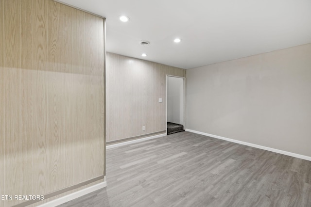 empty room with recessed lighting, visible vents, light wood-style flooring, and baseboards