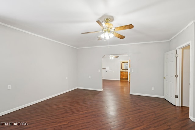empty room featuring a ceiling fan, crown molding, baseboards, and dark wood-style flooring