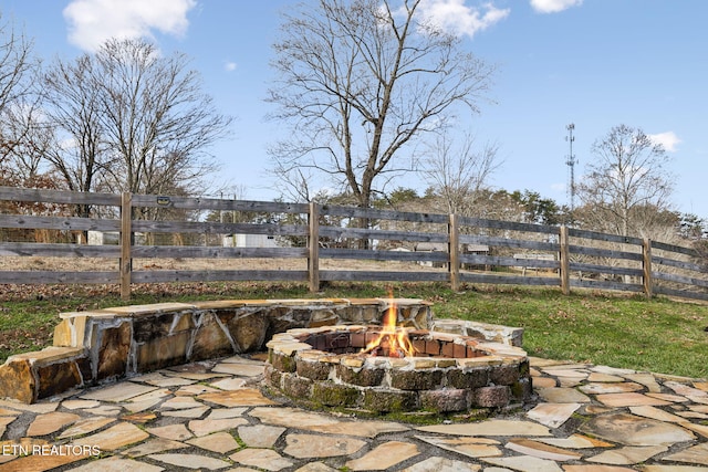 view of patio / terrace featuring a fire pit and fence