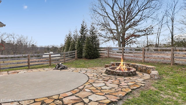 view of yard with a fire pit, a patio area, and fence