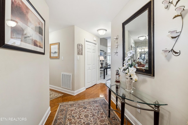 corridor with hardwood / wood-style flooring