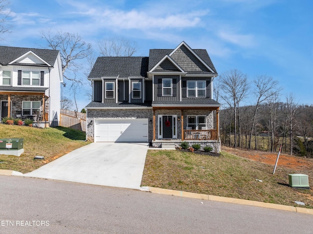 view of front facade featuring a front lawn, a porch, and a garage